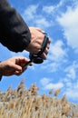 ManÃ¢â¬â¢s hands holding a video camera